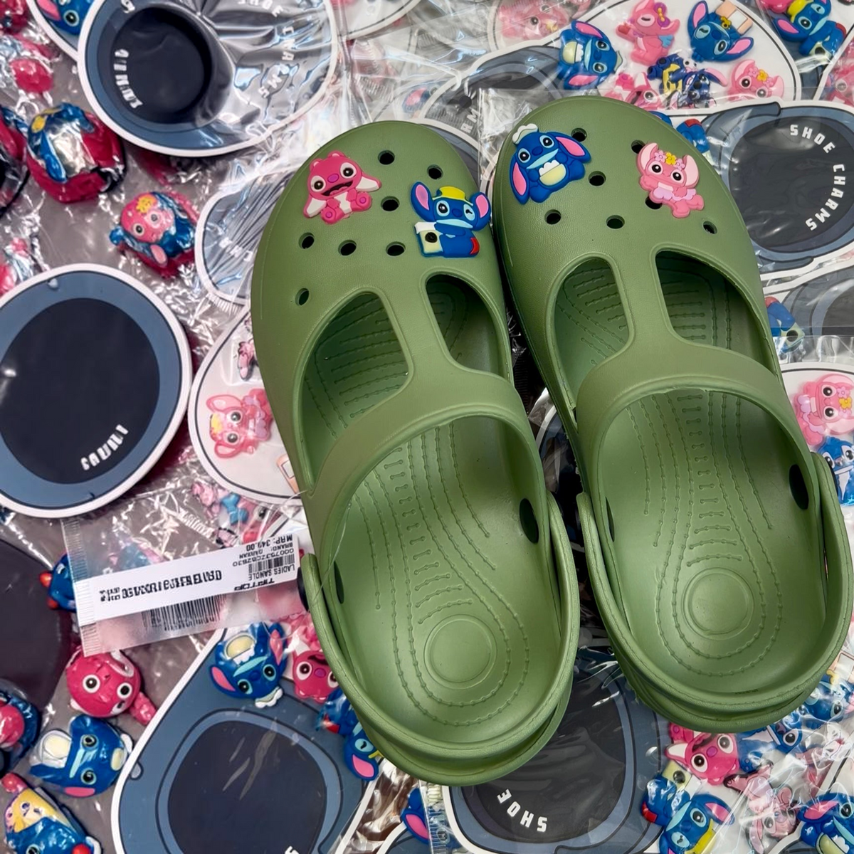 TipTop Retail olive green clog shoes decorated with colorful rubber character charms in a retail packaging setting