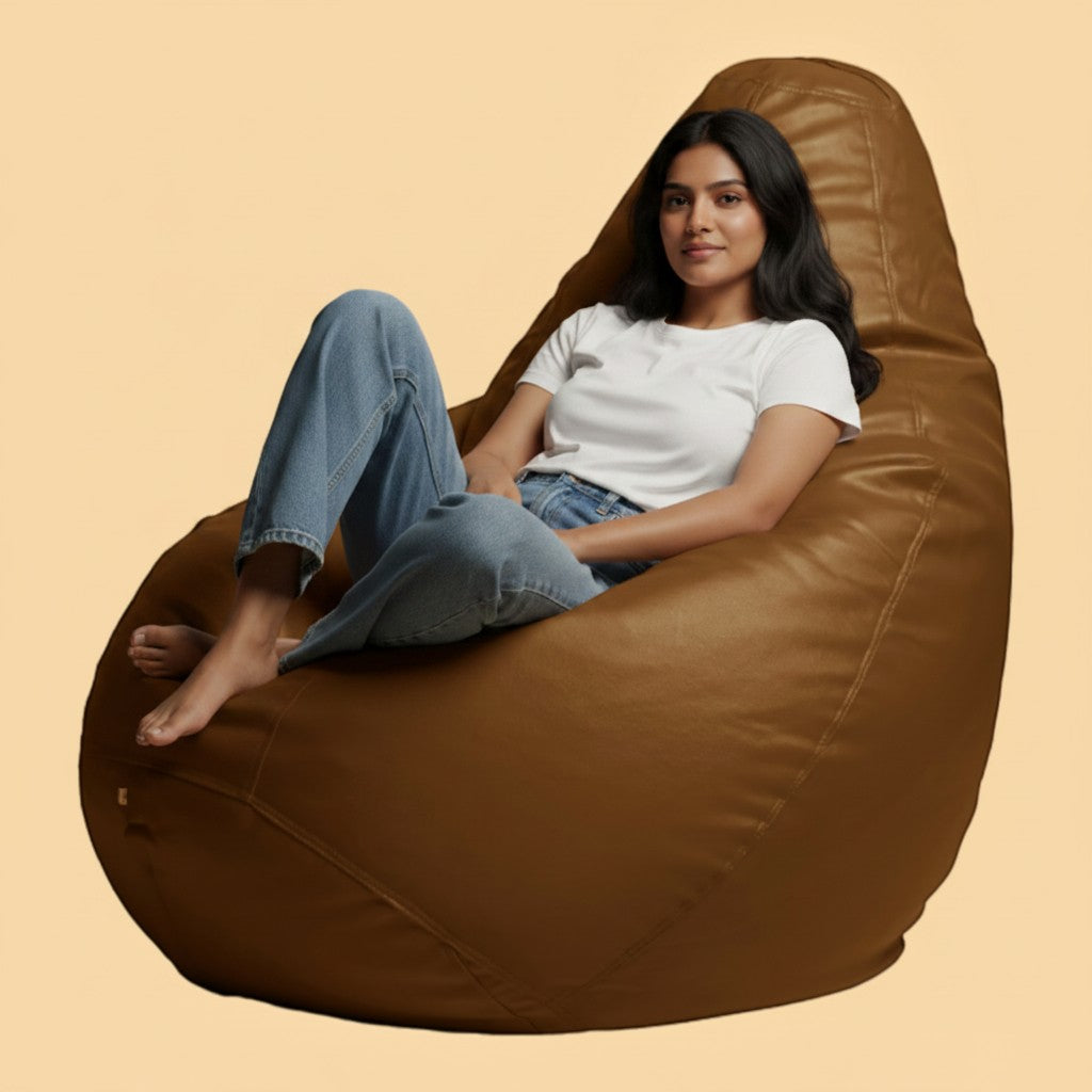 Woman sitting on a TipTop Retail clay brown teardrop bean bag chair made of durable fabric for cozy lounging.